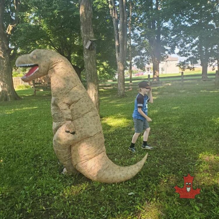 picture of me in an inflatable dinosaur suit chasing a laughing kid around the park for our community backyard summer camp